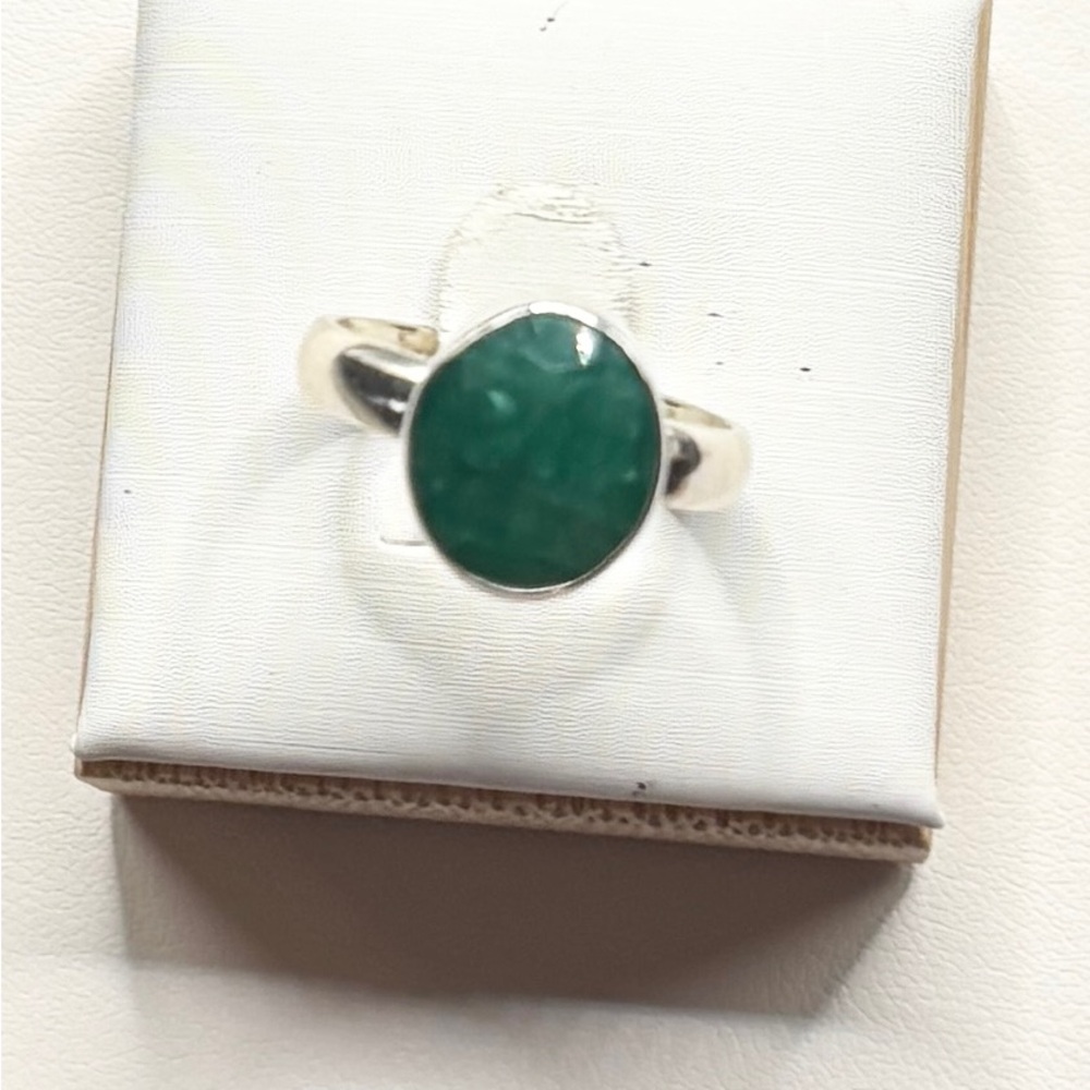A Raw Emerald stone set in a Sterling Silver dangle Earring